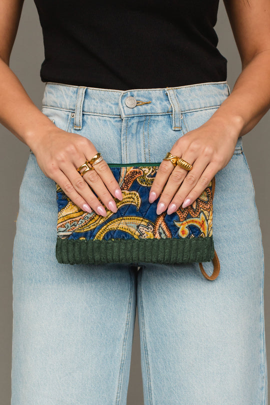 Front view of Panache Apparel Collection’s green multicolored wristlet featuring a vibrant paisley-inspired pattern and zipper closure.