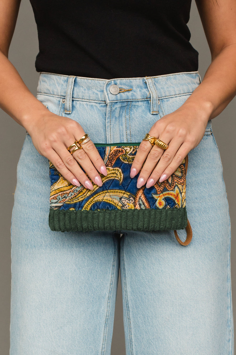 Front view of Panache Apparel Collection’s green multicolored wristlet featuring a vibrant paisley-inspired pattern and zipper closure.