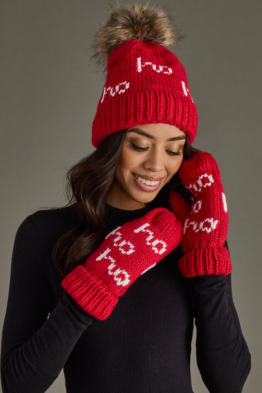 Person wearing a red knit hat and mittens with white text on a gray background