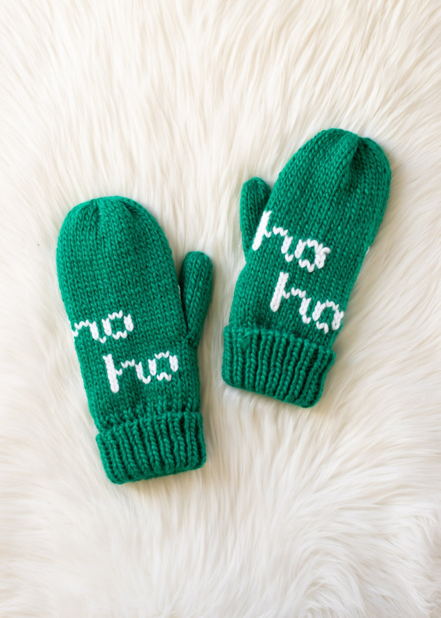 Pair of green mittens with 'ho ho' text on a white fur background