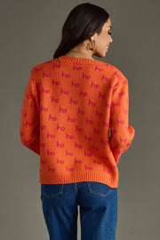 Person wearing an orange sweater with 'ho ho ho' pattern on a gray background