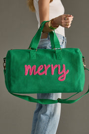 Green bag with 'merry' in pink text held by a person against a gray background