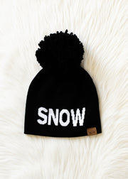 Black beanie with 'SNOW' text on a white textured background