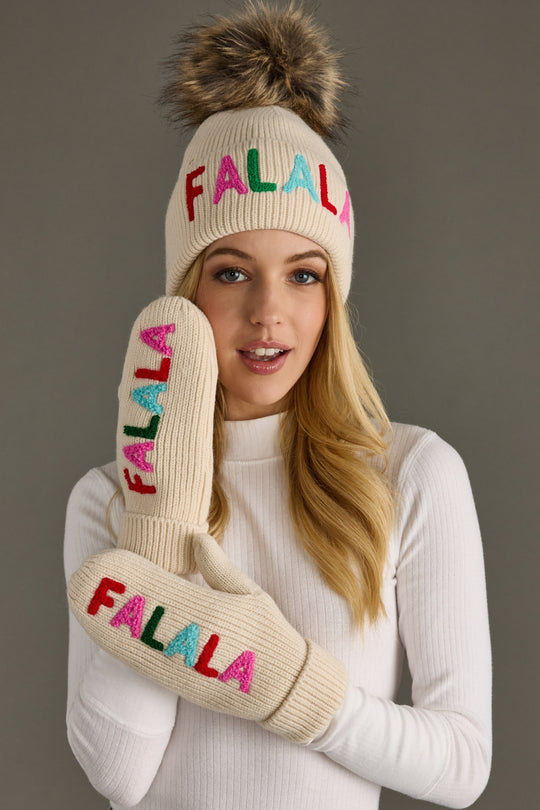 Person wearing a 'FALALA' beanie and mittens against a gray background