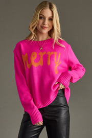 Woman wearing a bright pink sweater with orange text on a gray background