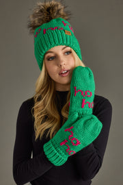 Person wearing a green knitted hat and gloves with pink text on a gray background