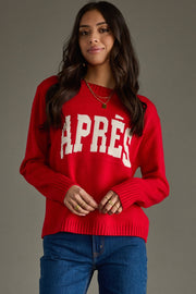 Woman wearing a red sweater with 'APRèS' text on a gray background