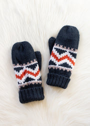 Pair of navy blue mittens with colorful zigzag pattern on a white textured background