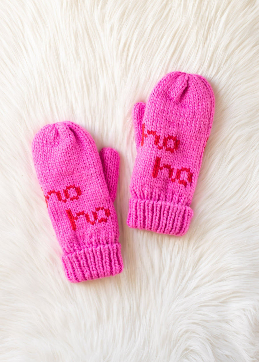 Pair of pink mittens with 'ho ho ho' text on a white fur background