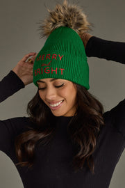 Woman wearing a green beanie with red text against a gray background