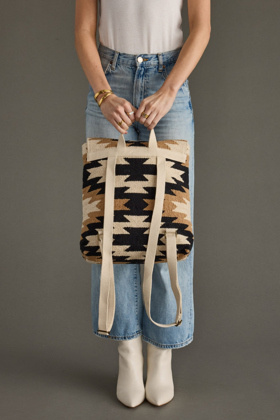 Person holding a patterned bag with a plain background