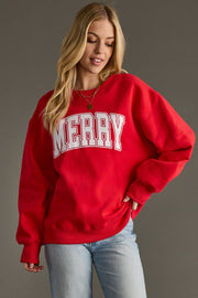 Person wearing a red sweatshirt with 'MERRY' text on a gray background