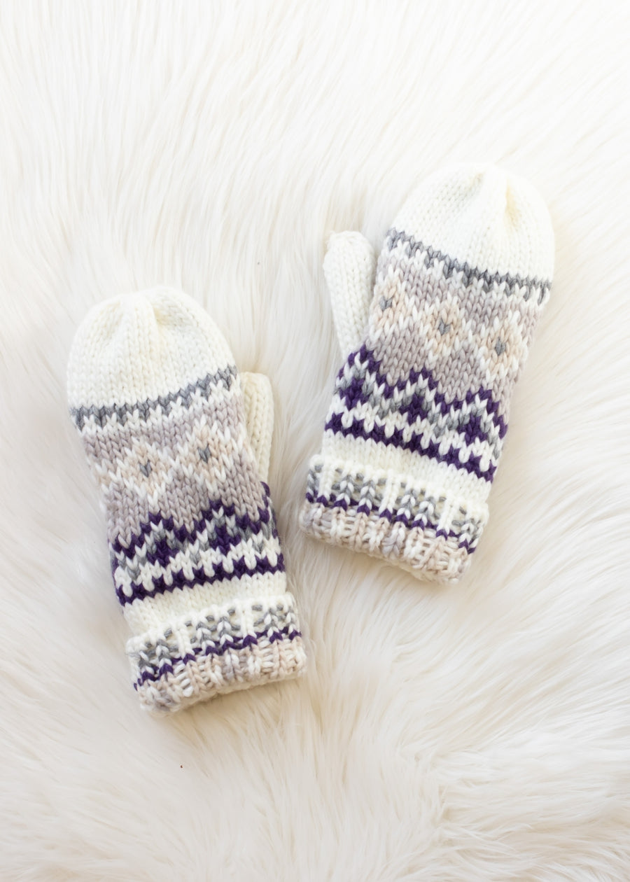 Pair of knitted mittens with purple and white pattern on a soft white background