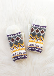 Pair of knit mittens with a geometric pattern on a white textured background