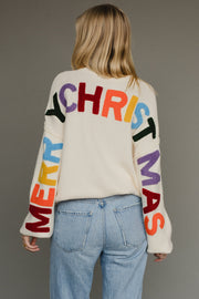 Ivory knit sweater with multicolored 'Merry Christmas' text on the back