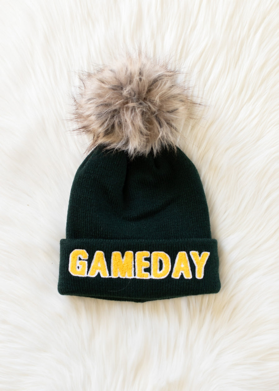 Green beanie with 'GAME DAY' text and fur pom-pom on a white background