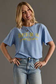 Woman wearing a blue t-shirt with 'Beer & Sunshine' text on a gray background