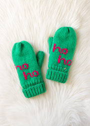 Green mittens with 'ho ho' text on a white fur background