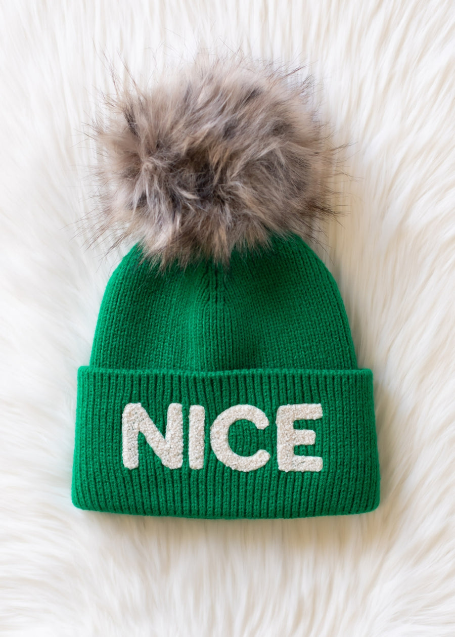 Green beanie with fur pom-pom and 'NICE' text on a white background
